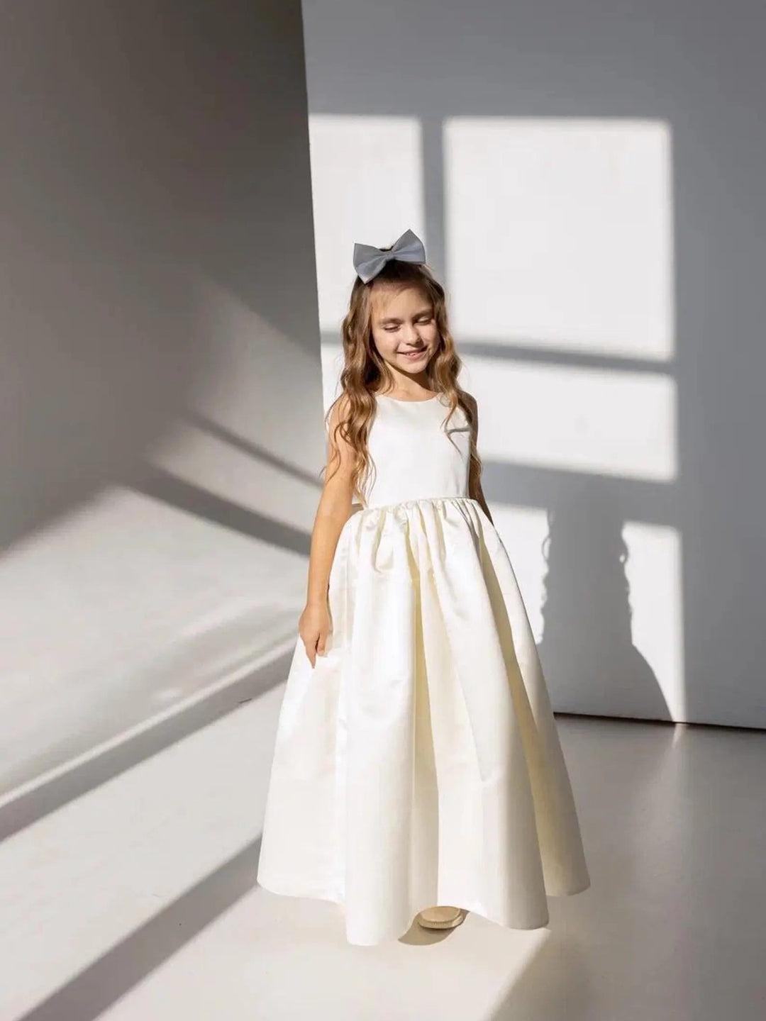 TinyTulle Elegant Ivory Satin Backless Flower Girl Dress with a Statement Bow for Weddings