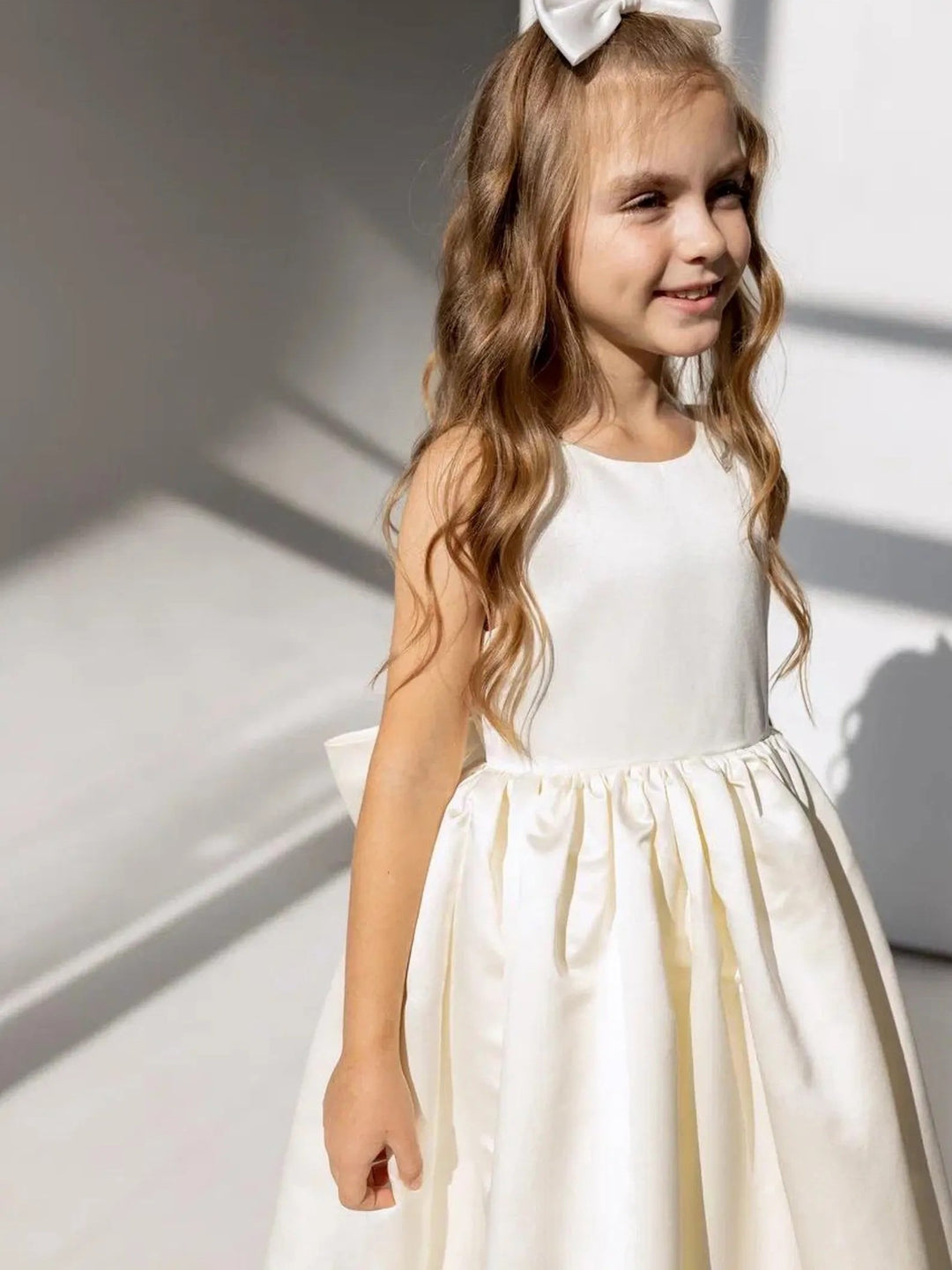 TinyTulle Elegant Ivory Satin Backless Flower Girl Dress with a Statement Bow for Weddings