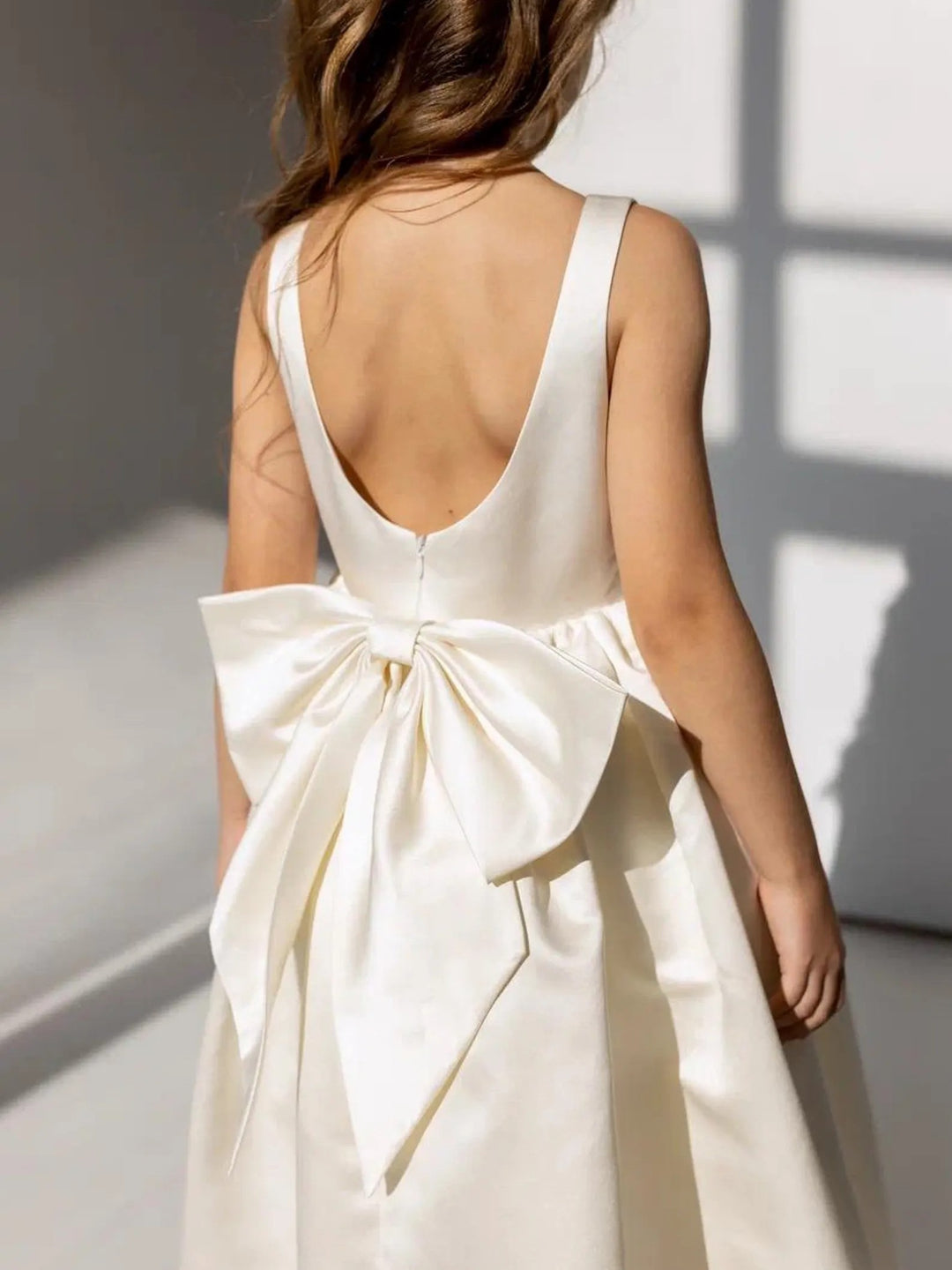 TinyTulle Elegant Ivory Satin Backless Flower Girl Dress with a Statement Bow for Weddings